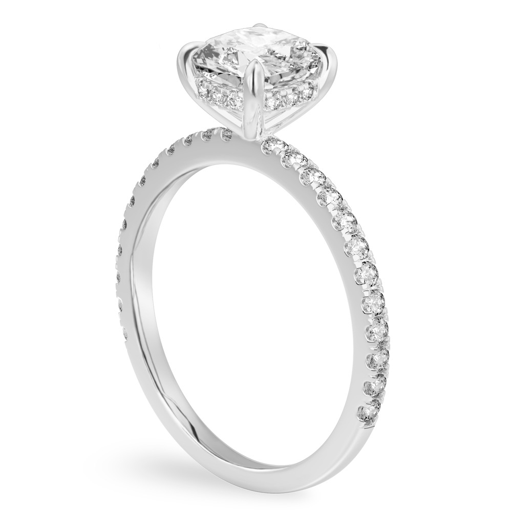 Angle view of cushion cut diamond delicate pave hidden halo engagement ring in white gold