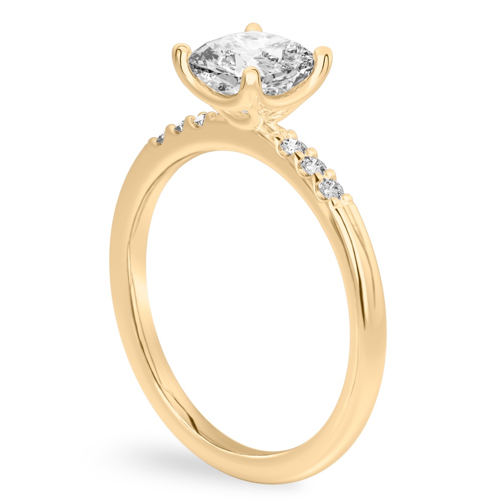 Angle view of cushion cut diamond minimalist pave engagement ring in yellow gold