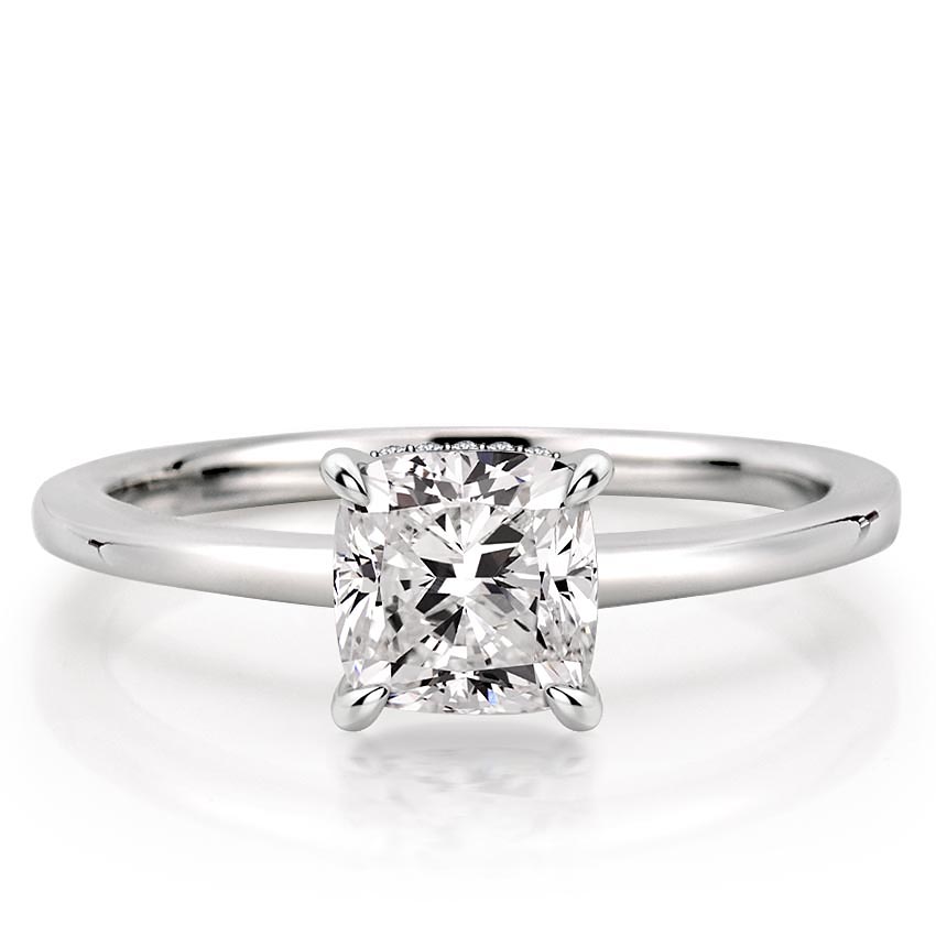 cushion cut diamond secret halo engagement ring in white gold