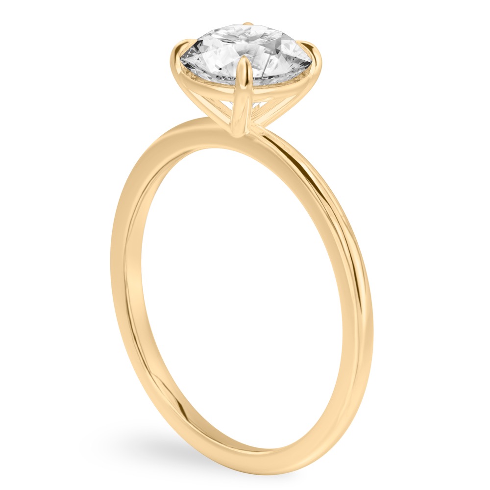 Angle view of four prong round cut diamond delicate solitaire engagement ring yellow gold