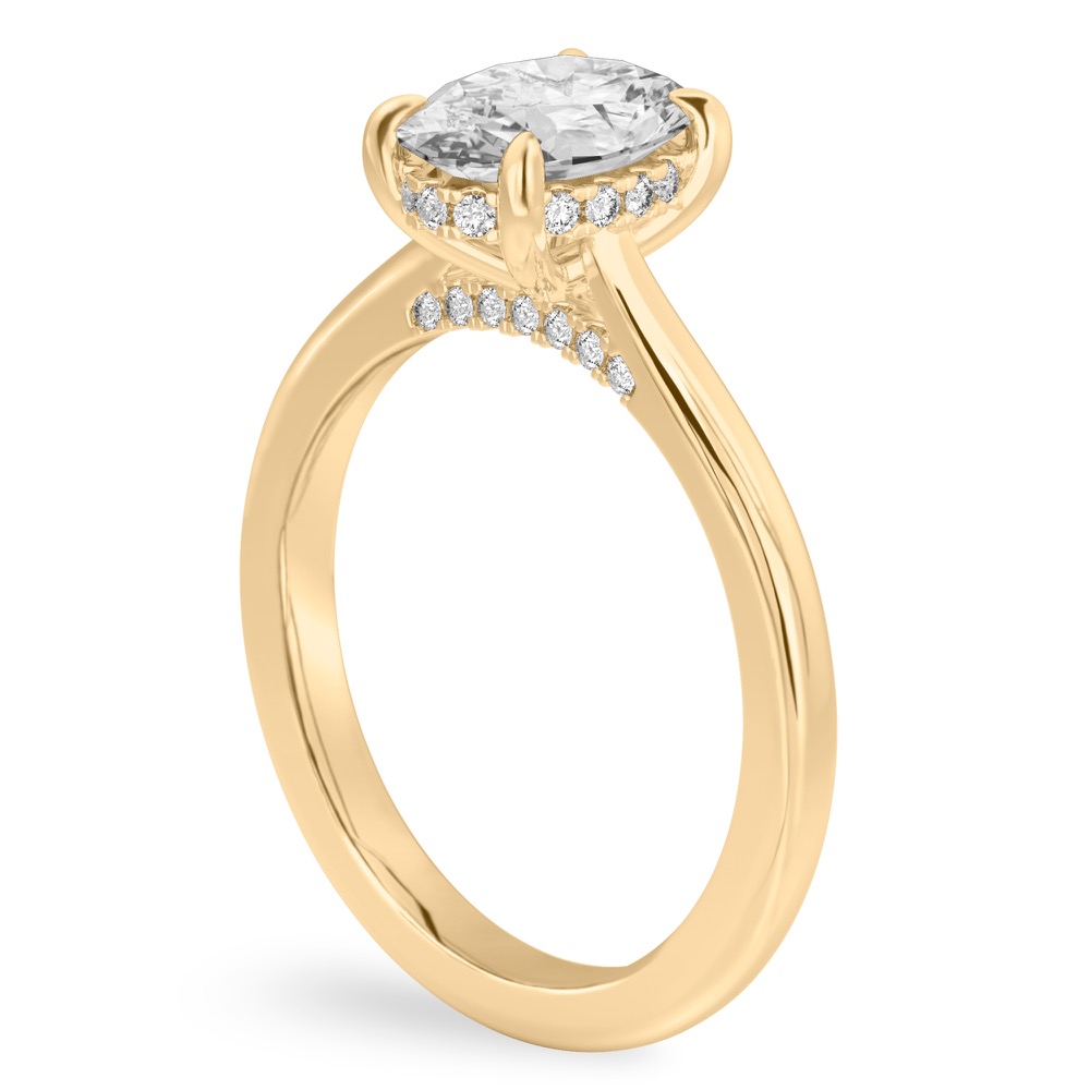 Angle view of oval cut diamond pave bridge engagement ring in yellow gold