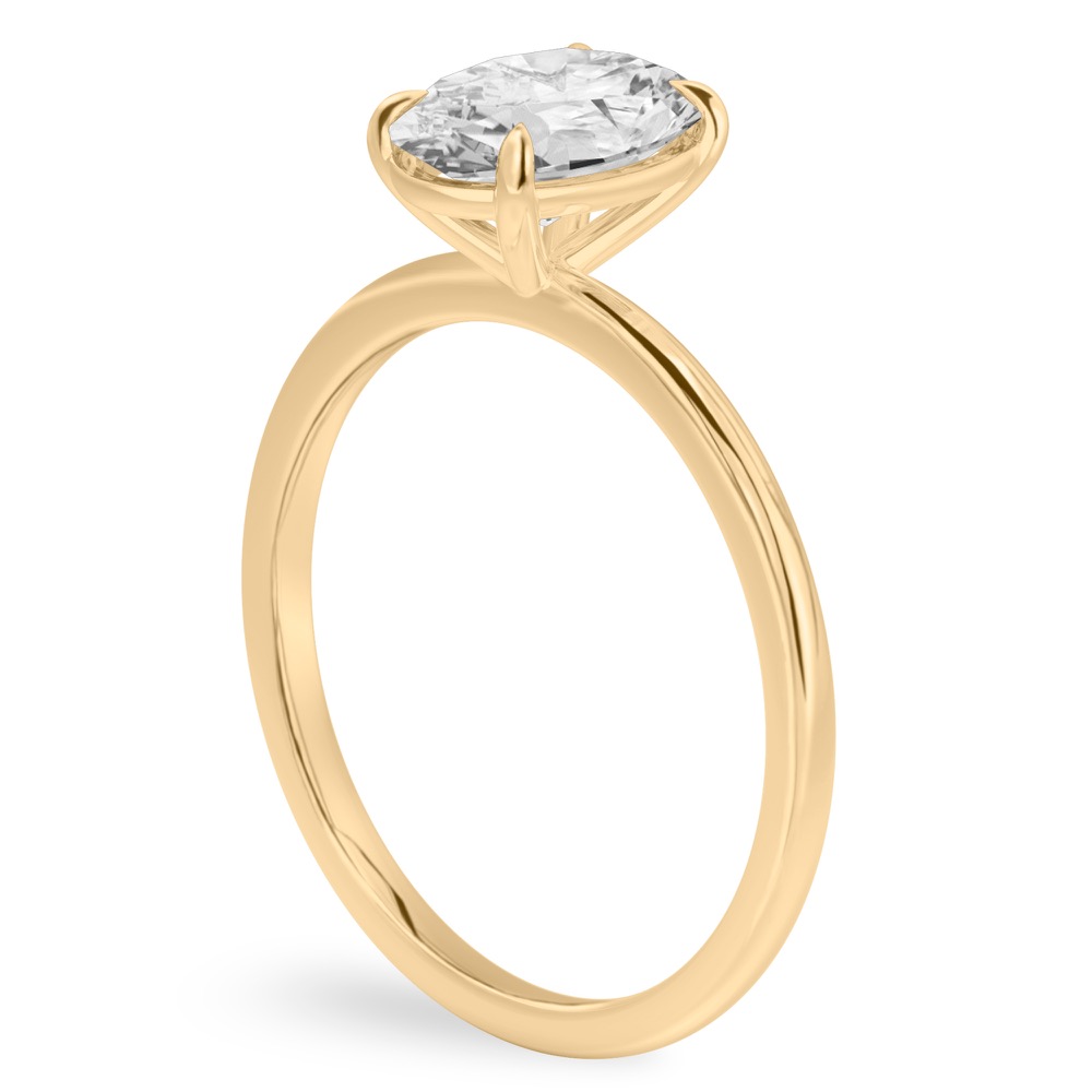 Angle view of oval shape diamond delicate solitaire engagement ring yellow gold