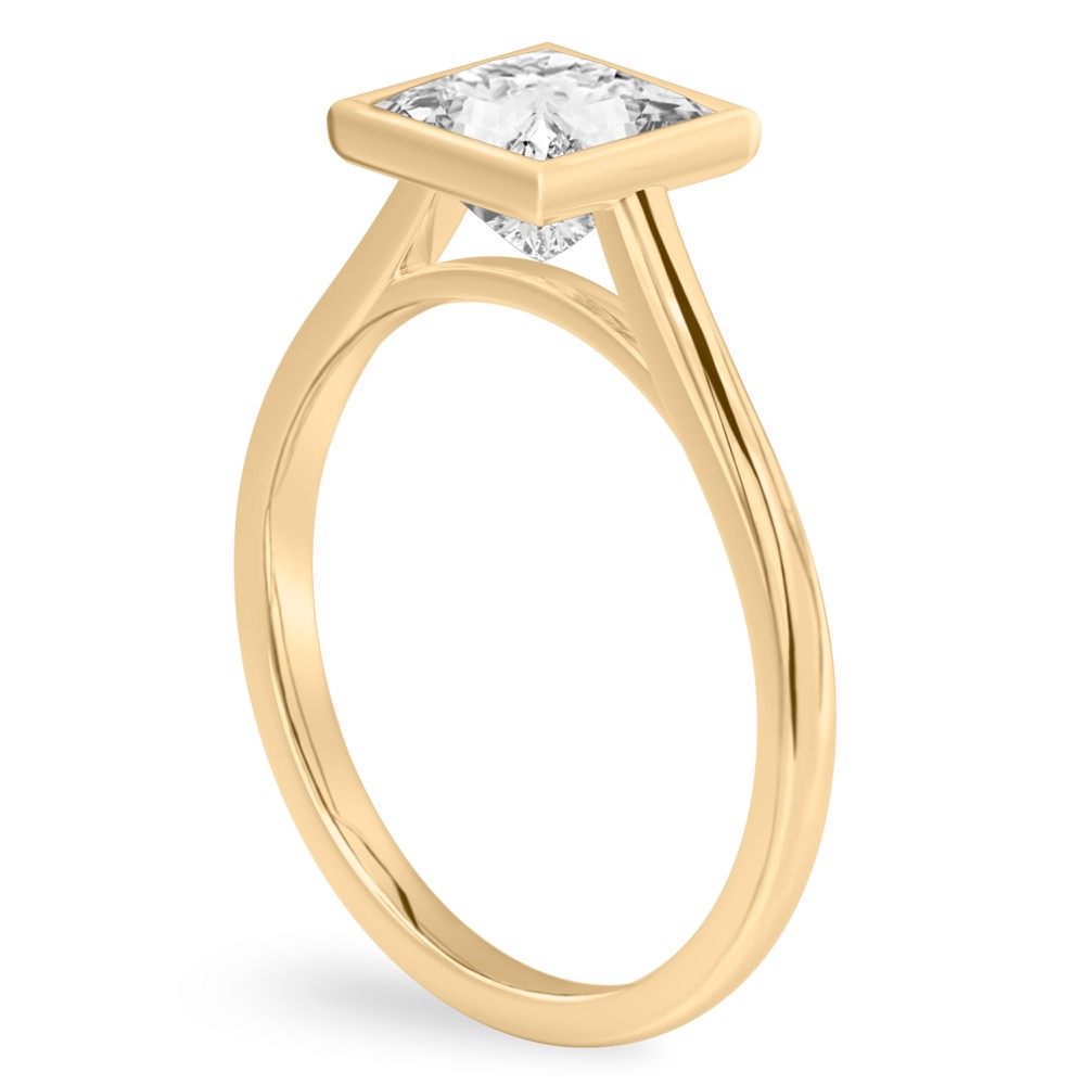 Angle view of princess cut diamond bezel engagement ring in yellow gold