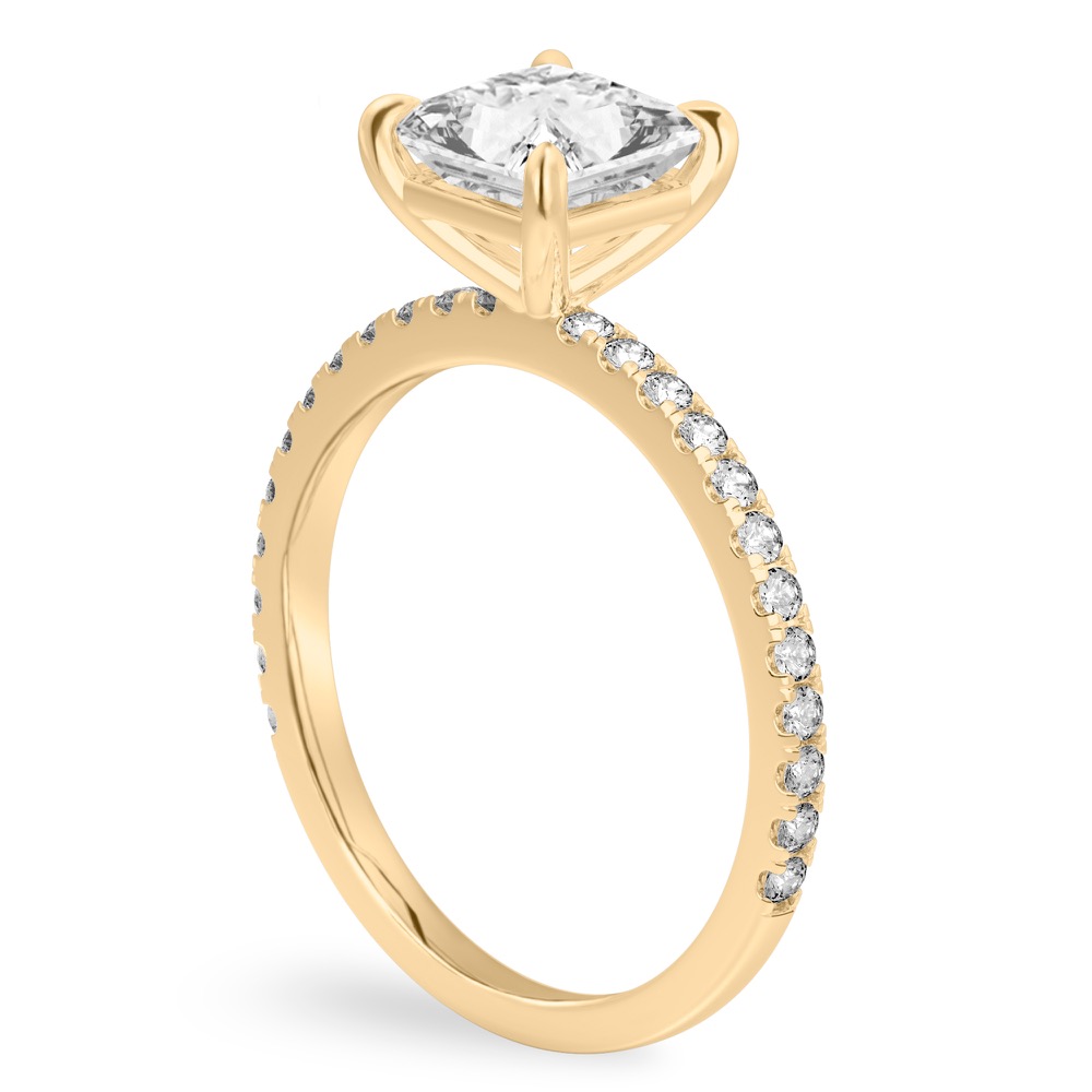 Angle view of princess cut diamond delicate pave engagement ring in yellow gold