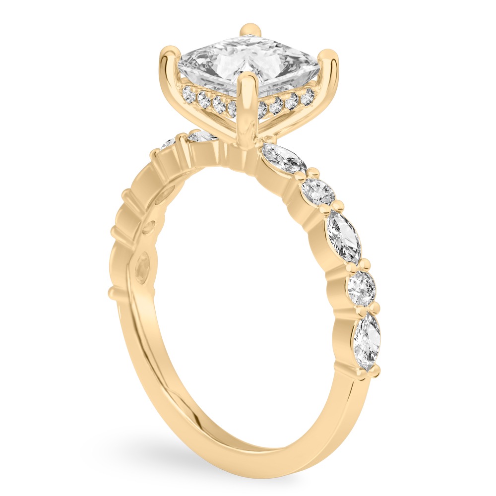 Angle view of princess cut diamond hidden halo marquise and round diamond ring yellow gold