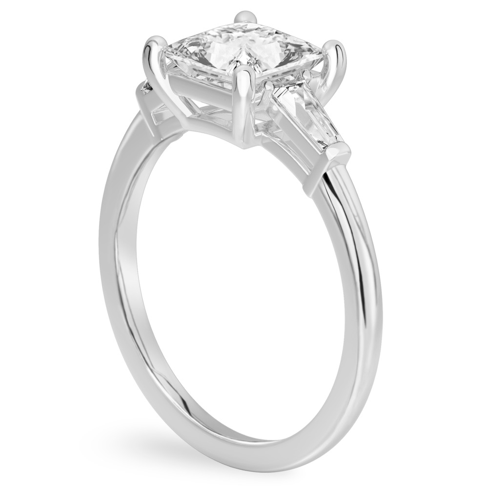 Angle view of princess cut diamond tapered baguette engagement ring in white gold