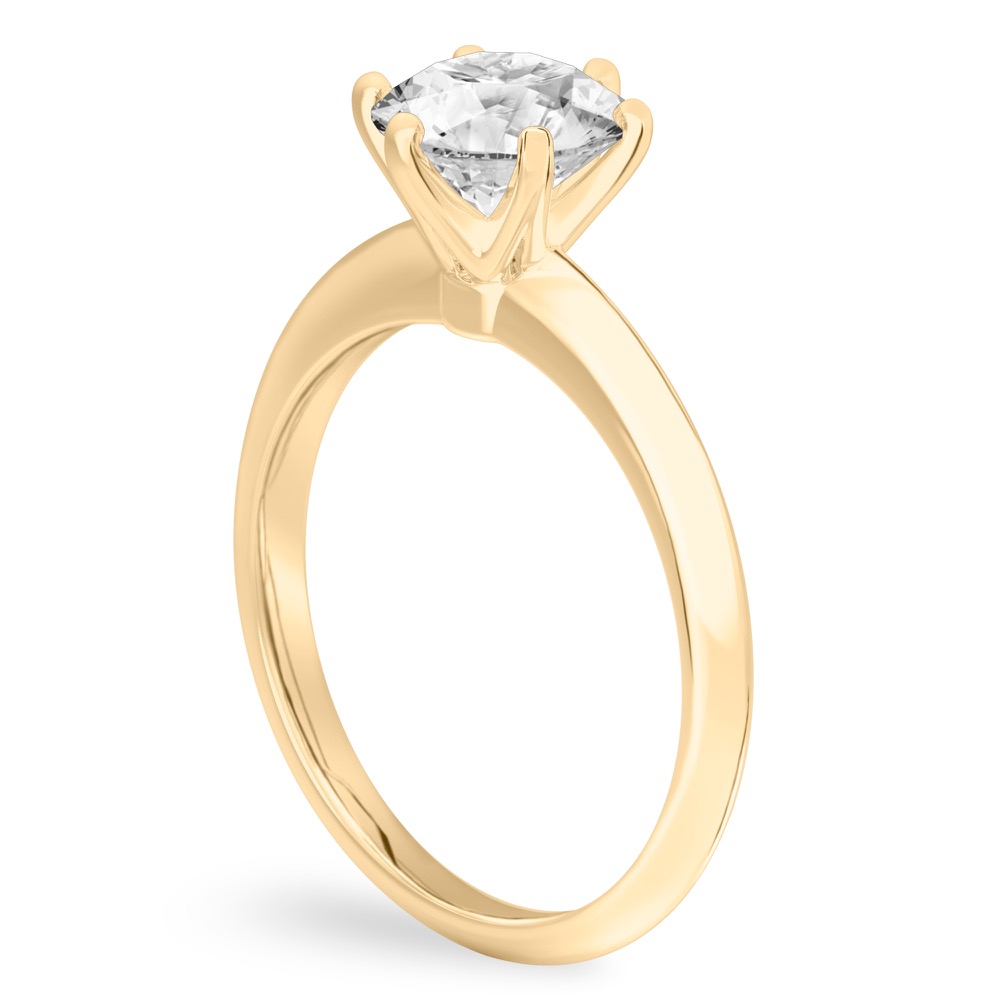 Angle view of round cut diamond six prong engagement ring in yellow gold